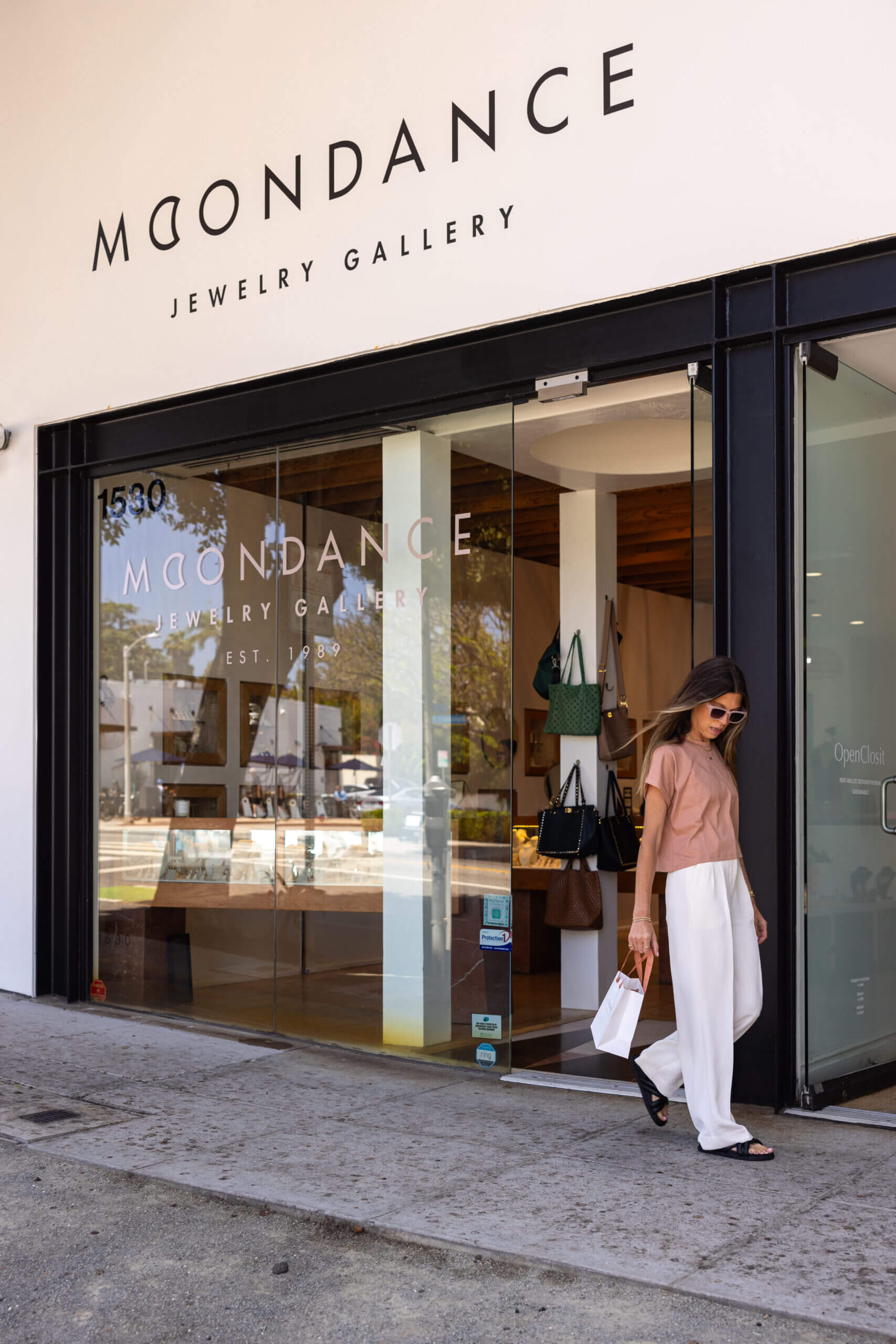 Suzanne Scott walking in front of Moondance Jewelry Gallery in Santa Monica, CA