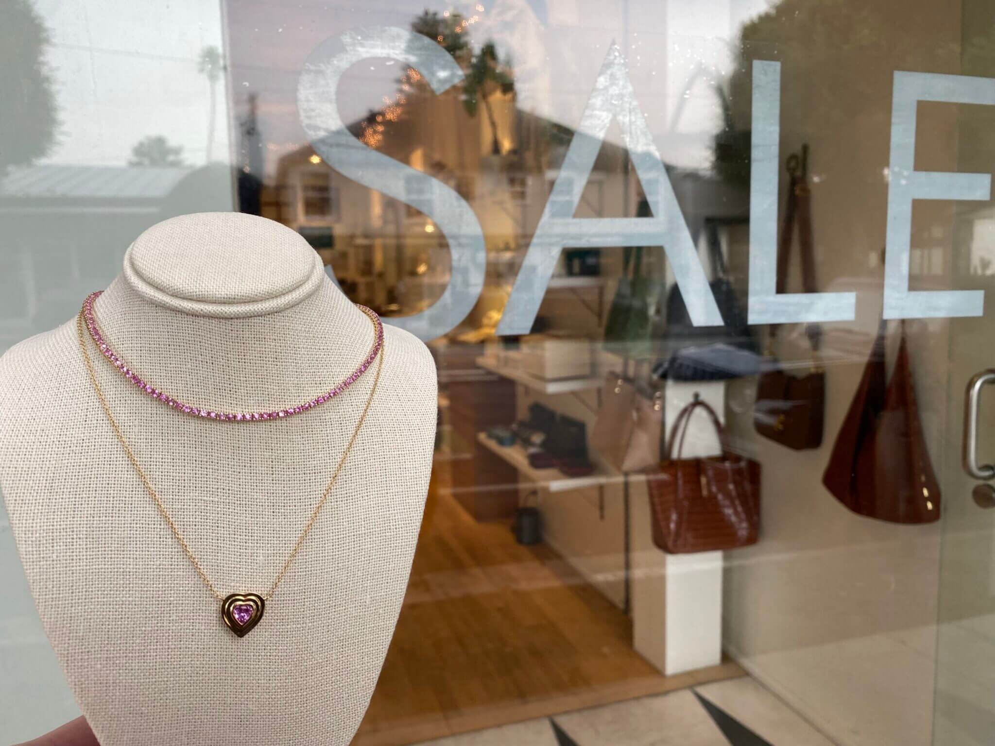 Shop Moondance Jewelry Gallery's New Years Sale - Window with SALE in it and pink necklaces