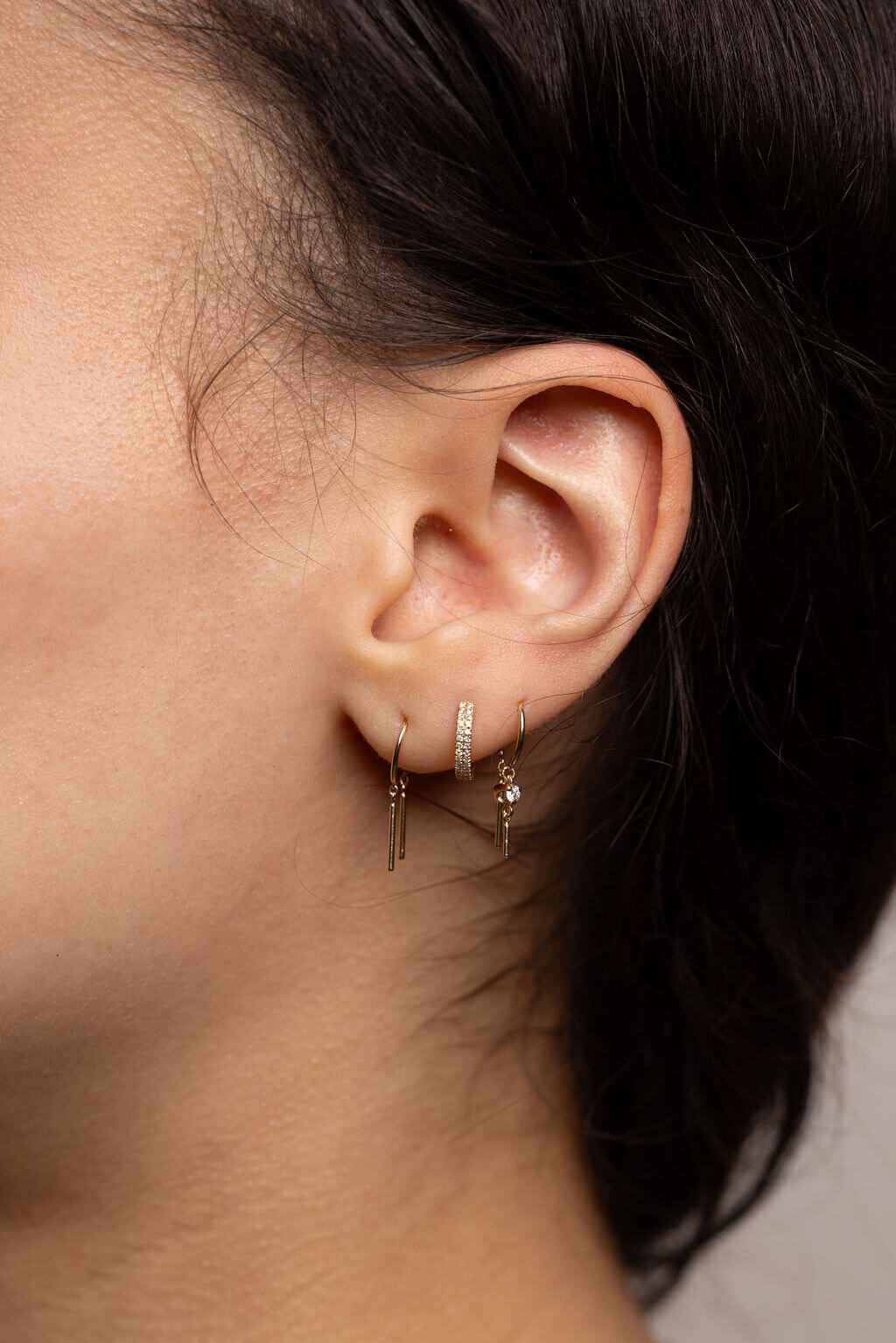 3 Different Sets of Huggies Earrings on Ear - All available at Moondance Jewelry Gallery